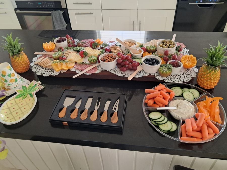 Charcuterie spread with fruit, cheeses and carved pineapples