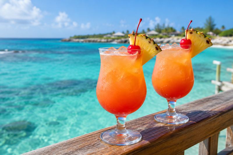 Two rum punches over turquoise water